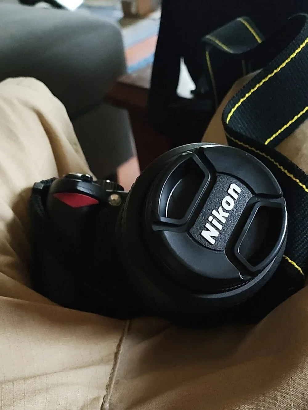 Nikon Black DSLR with Telephoto Lens and Branded Strap